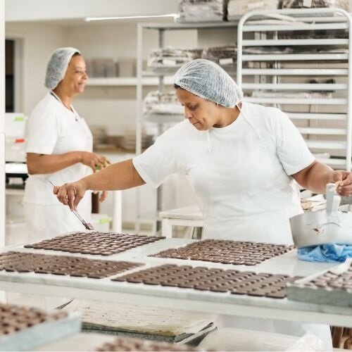 Production worker in a chocolate factory